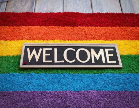 A bright welcome mat on a rainbow rug symbolizes unity and inclusivity at Pride.の素材
