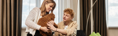 In a modern hotel, a young couple lovingly interacts with their adorable pet, radiating happiness.