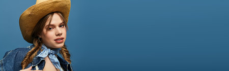 A young woman in a denim jacket exudes a spring vibe against a blue backdrop, bannerの写真素材