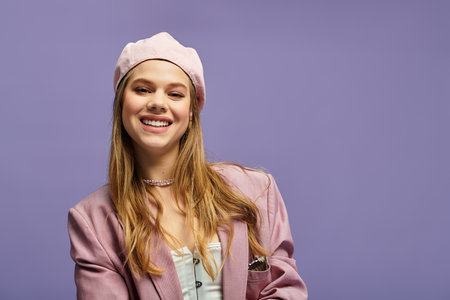 A young woman showcases a chic spring outfit with a joyful smile in a vibrant studio background.の写真素材