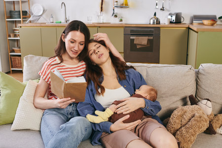 Two mothers celebrate Mothers Day with their child in a cozy, tender moment at home.