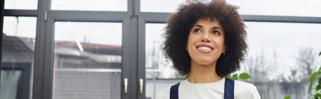 A woman enjoys packing her belongings into boxes, preparing for a fresh start in a new home.のeditorial素材