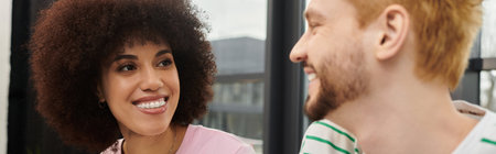 Friends joyfully pack household items together, excited for their new adventure.の写真素材