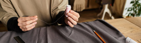 A young woman skillfully threads a needle in a cozy, inspiring crafting space.
