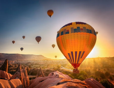 Hot air balloons ascend gracefully over stunning rock formations at dawn, creating a magical view.の素材