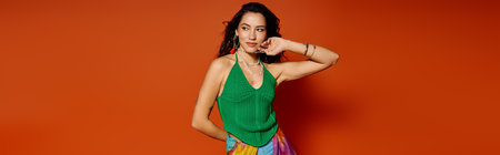 A young beautiful woman radiates joy, showcasing a modern summer outfit against a lively backdrop.のeditorial素材