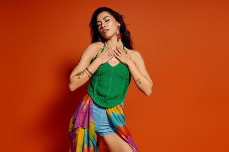 A young beautiful woman enjoys summer vibes, wearing colorful attire against a bright background.のeditorial素材