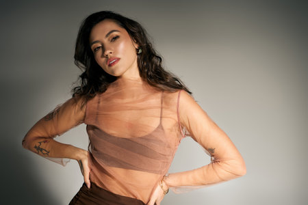 A young beautiful woman showcases her stylish summer outfit, radiating confidence and charm.