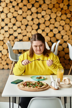 A young woman with Down syndrome enjoys her meal at a casual cafe, showcasing confidence and style.のeditorial素材
