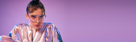 A young woman wears holographic attire, radiating beauty and confidence in a vibrant setting.