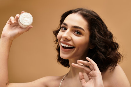 Bright and cheerful young woman demonstrates her beauty routine while showcasing radiant skin.のeditorial素材
