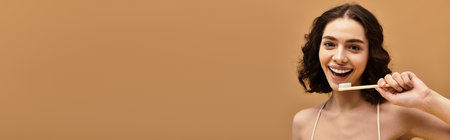 Pretty young woman with braces showcases her dental regimen while smiling broadly in the studio, bannerのeditorial素材