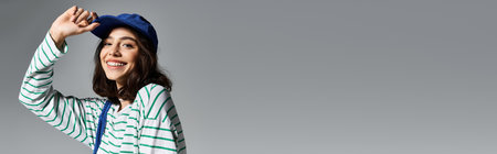 A young woman radiates confidence as she sports a trendy summer outfit while smiling joyfully.