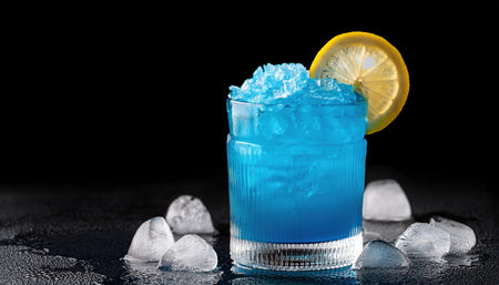 Bright blue beverage garnished with a lemon slice surrounded by ice, perfect for hot summer days.の素材