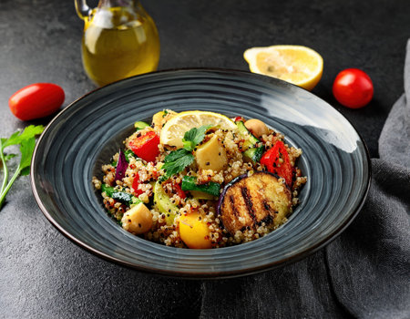 Enjoy a vibrant quinoa salad featuring grilled vegetables, fresh herbs, and a zesty lemon garnish.の素材
