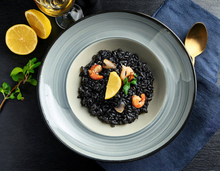 Delicious black risotto served in a stylish bowl, perfect for a warm summer evening.の素材