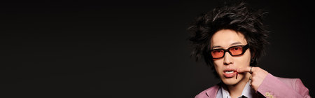 An asian man with blood on face displays modern spring fashion with unique styling in a studio space, bannerの写真素材