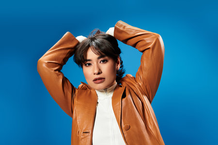A stylish young Asian woman exudes confidence with her bold pose and striking expression.