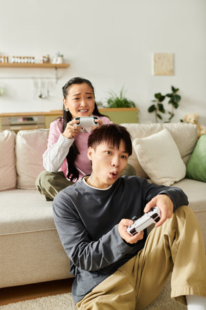 A couple sits on a couch engaged in an exciting gaming session at home, sharing laughter and energy.