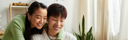 A young couple shares a joyful breakfast moment at home, smiling and relaxing in a cozy atmosphere, bannerの写真素材