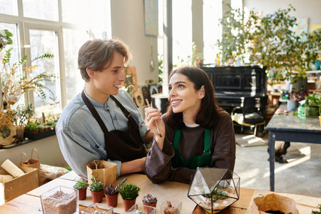 Creative couple share laughter and ideas while working on a project in a vibrant art studio.のeditorial素材