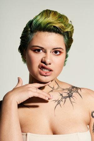 A young, beautiful woman flaunts vibrant hair and artistic makeup, exuding confidence and style.のeditorial素材