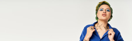 Colorful attire and unique makeup highlight the confidence of a young woman posing stylishly.のeditorial素材