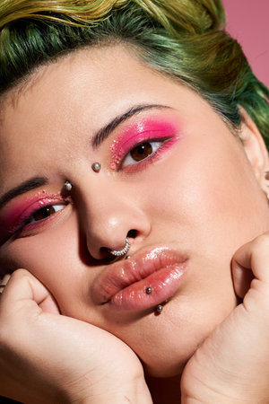 A young woman poses confidently, her striking makeup reflecting her vibrant style and personality.
