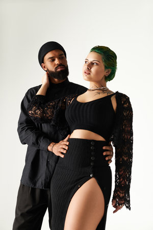 A fashionable young couple poses confidently together in a studio, embodying modern style.のeditorial素材