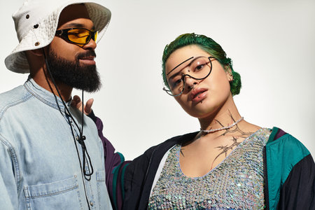 A stylish young couple shows off their unique outfits and confidence while posing indoors.のeditorial素材