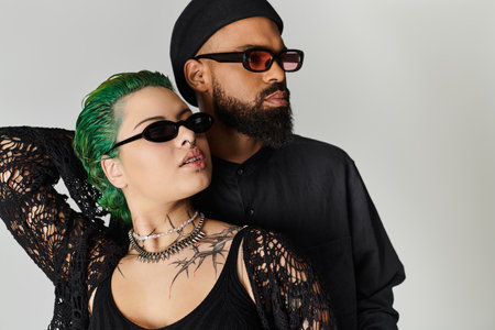 A fashionable couple poses confidently in stylish outfits, exuding charisma and diversity.の写真素材