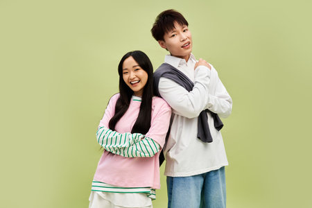 A stylish couple shares a playful moment, celebrating their love in a vibrant setting.のeditorial素材