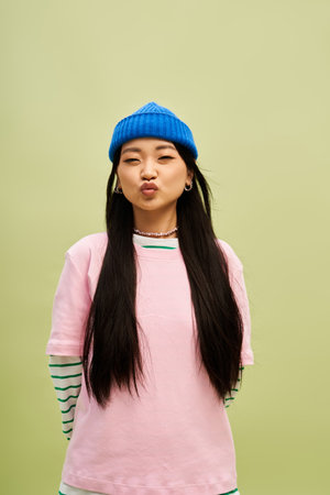 Attractive chic woman in fashionable casual attire posing cheerfully.のeditorial素材