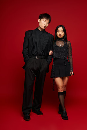 Charming duo showcases fashion forward outfits in a romantic pose, radiating connection and style.のeditorial素材