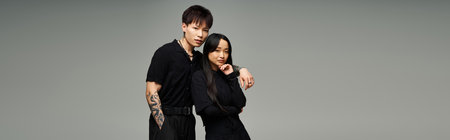 A stylish couple exudes love and romance with their chic outfits and confident poses.のeditorial素材