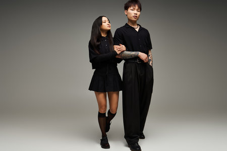 A stylish couple poses closely in a chic studio, showcasing love and fashion through their looks.のeditorial素材