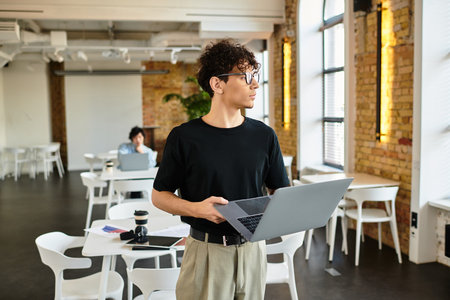 Individual exudes confidence with a laptop in a stylish, productive workspace.のeditorial素材