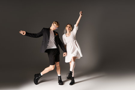 A joyful couple dances together, celebrating their wedding in a beautiful spring atmosphere.のeditorial素材