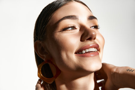A young woman with sun-kissed skin radiates joy and beauty, embracing summer warmth.