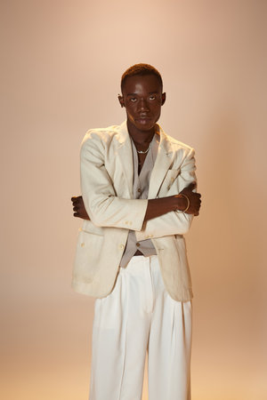 Confident young african american man showcases his unique style in a trendy outfit.
