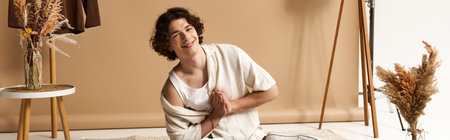 A handsome young man models a stylish summer outfit, flaunting his curly hair and joy, banner