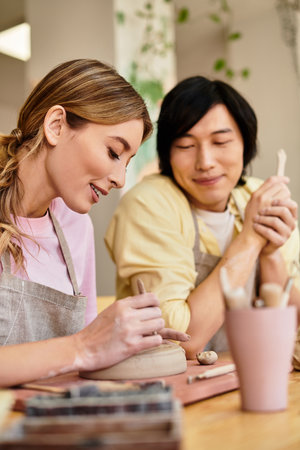 Young couple makes pottery together, creating unique pieces filled with smiles and love.