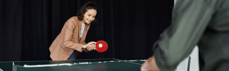Colleagues enjoy a spirited game of table tennis, fostering camaraderie and fun at work.