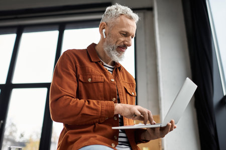 A focused individual interacts with a laptop while seated comfortably in a chic office setting.