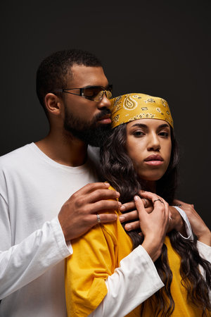 Stylish couple shares a tender moment, highlighting love and creativity.の写真素材