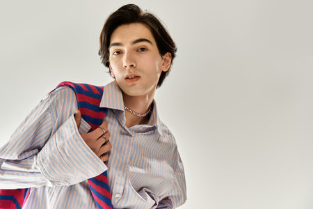 A young non binary person expresses unique fashion sense with confidence and pride.の写真素材