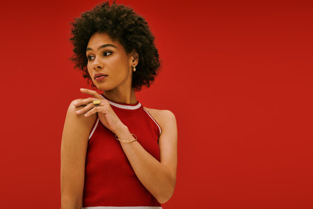 Beautiful woman exudes confidence as she poses with elegance, highlighting her stylish attire.のeditorial素材