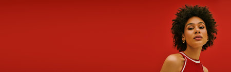 A young woman flaunts her unique style and confidence in a vibrant setting.の写真素材