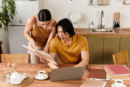 Warm moments shared as a couple looks through a book together in their inviting kitchen space.の写真素材