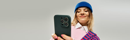 Confident young woman captures a moment while dressed in a trendy outfit and beanie hat, banner